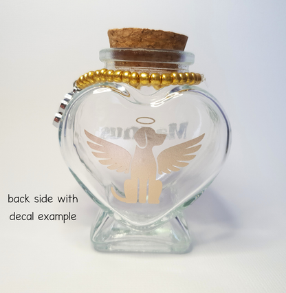 The photo displays the back of the bottle where a gold vinyl decal of a dog with wings and a halo has been placed.