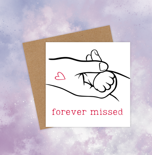 Sympathy card for a pet cat, featuring a human hand grasping a cat paw. Below, the red text reads, “Forever missed.”