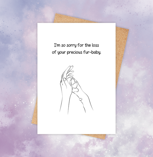 Pet loss sympathy card featuring a dog paw placed against a human hand with the words “I’m so sorry for the loss of your precious furbaby.”
