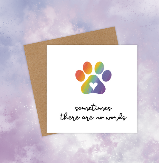 This pet sympathy card features a rainbow-coloured paw print in the centre and the text below reads, “Sometimes there are no words.”