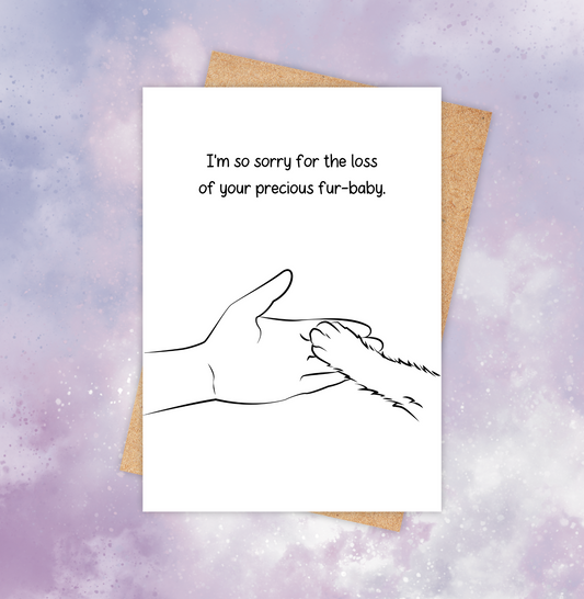 Pet loss sympathy card featuring a cat paw on top of a human hand with the words “I’m so sorry for the loss of your precious fur-baby.”